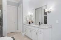 Features separate vanities and spacious walk-in closets