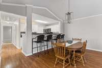 Dining area with new Chandelier, and bar area, leading into Kitchen