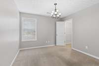 This is the 2nd Bedroom, which boast of a very large walk in closet. And great window to bring in natural light. Plus very pretty Chandelier.