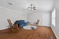 Open concept living room, with Vaulted ceilings, Ceiling fan, and New paint throughout the home. Big front window that overlooks the Patio/Courtyard area. Plantation Blinds throughout the home