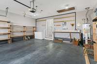 2 car garage (without the shelving) or extra large space for one car. Shelving to stay and freezer to stay also, if new Buyer wishes. Nice work bench area also. 2 areas for attack access. One is here in the garage. Other in the hallway.