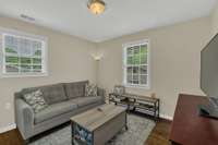 This room has plenty of natural lighting. Also has a view of back yard as well as the side parking area.