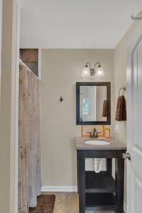Primary suites bathroom sink and shower access left.