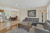Living room features hard wood floors and  is open to eat in Kitchen with stainless steel appliances and tile floors. Natural lighting pours through the front and rear of this beautiful home.