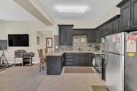 Efficiency apartment boasts it ow full size kitchen with, tile, granite and stainless steel appliances.
