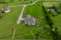 From this perspective, you can see the nature paths the owners have cut in to the lawn throughout the property. On the right side of the image, you can see the English sitting garden against the house and the pond garden in their full glory.