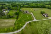 Spanning 5.7 acres, this property features a long driveway intentionally and thoughtfully planted with trees lining the vast majority. The property includes two pastures, a chicken coup and run, horse barn and fully producing vegetable garden.