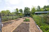 It has a poly tunnel frame – or a plastic covered greenhouse over garden beds which can be easily recovered with plastic and used for starting plants early or growing tomatoes or peppers in specific moisture conditions.
