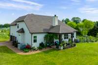 The covered patio provides the perfect evening spot to catch and outdoor movie or enjoy the view of the horse pasture and extensive grasses and native flowers that have been planted. Projector and screen can stay with home!