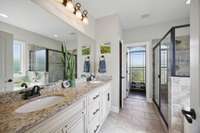 Primary suite features double sinks, separate tub and shower and a water closet.