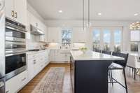 Host holiday feasts at this expansive island, featuring quartz countertops, gas cooktop, double ovens, and a charming cast-iron apron sink. Overlooks the backyard, bathed in natural light.
