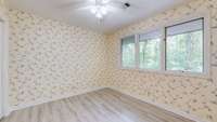 Bedroom 3 with new flooring and pleasing views of the private backyard.