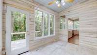 This sunroom comes off the kitchen. It can be entered from the outside or from the dining room.  This room may become one of your favorite rooms in the home!! And, as if that is not enough, there is yet another deck outside this charming room.