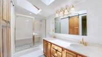 This is your large master bath with a large tiled shower and double sink vanity.