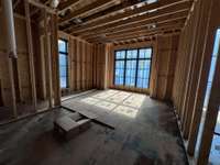 Primary Spa with two vanities, large curbless shower and luxurious free standing tub! * this home is under construction. Photo taken 6/17/25