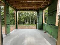 Rear covered grilling porch * this home is under construction. Photo taken 6/17/25