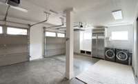 Oversized, climate controlled 2 car garage, with a washer and dryer, al large 2nd refrigerator, whole house water conditioner/filtration system and HVAC split units for the Geo Thermal system. Cabinets line the opposite wall for additional storage.