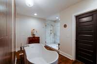 Deepen your relaxation at the end of a long day in this dreamy soaker tub! The door to the left gives way to the walk-in closet.
