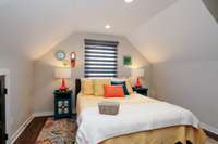 This cozy bedroom can comfortably fit a queen sized bed and has several storage areas.