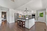 Large oversized eat in kitchen with 2 doors.  One to the side porch and the other to the front porch.