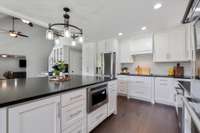 Beautiful wood hood vent is gorgeous with the white custom cabinetry.
