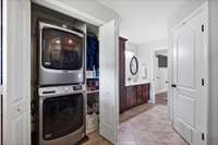 Stackable washer and dryer in the primary bathroom.
