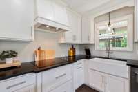 Enjoy views out the window while washing dishes in your white farm house sink.