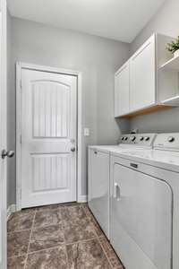 The laundry room is centrally located between the kitchen and garage.