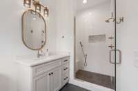 First floor bedroom suite includes a tile surround shower