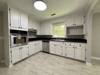 Kitchen w/ new countertop, sink, dishwasher, and cooktop