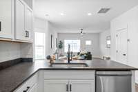 Kitchen sink looks out to the dining area and breakfast bar