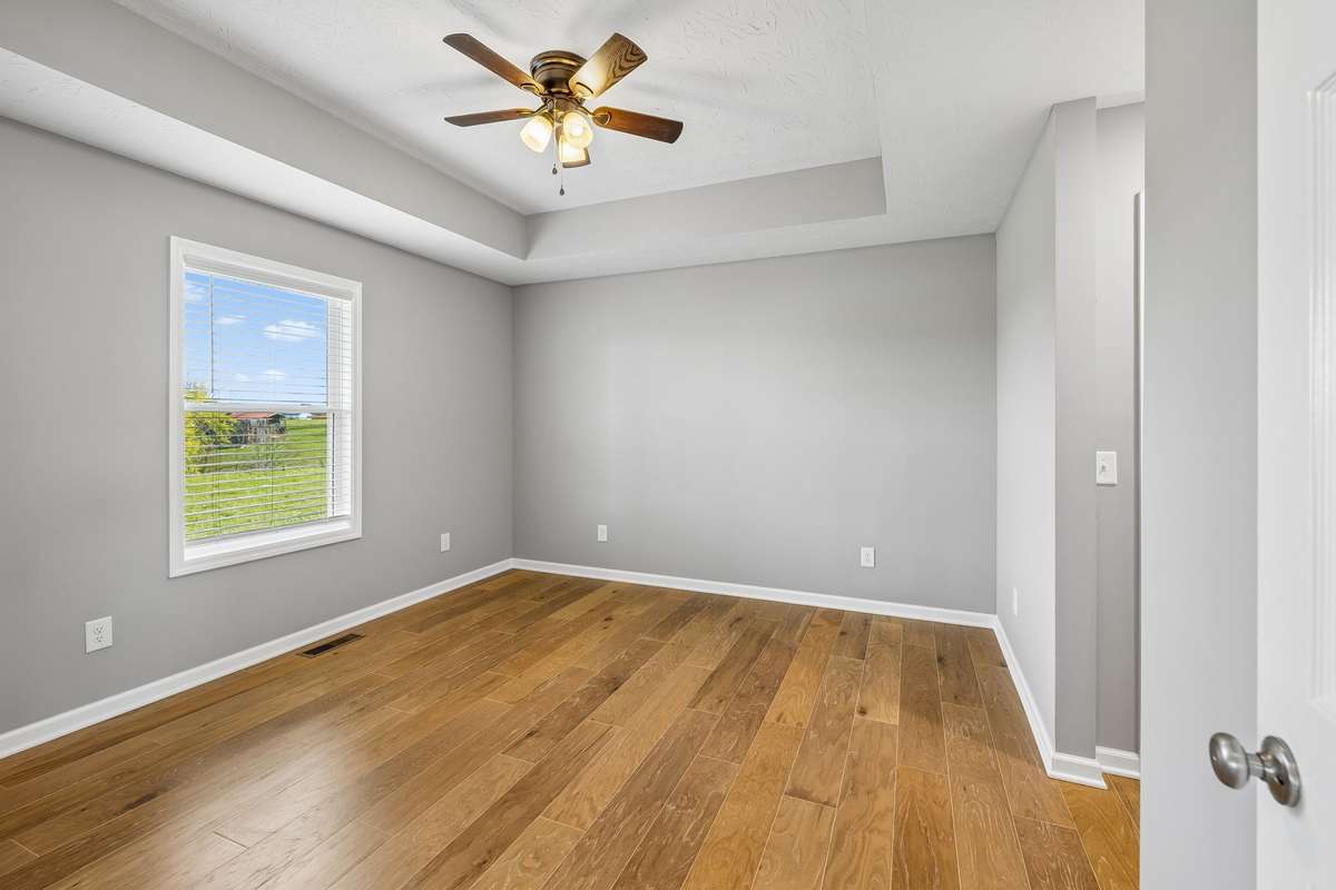 Spacious primary suite featuring tray ceilings and a comfortable, private retreat.
