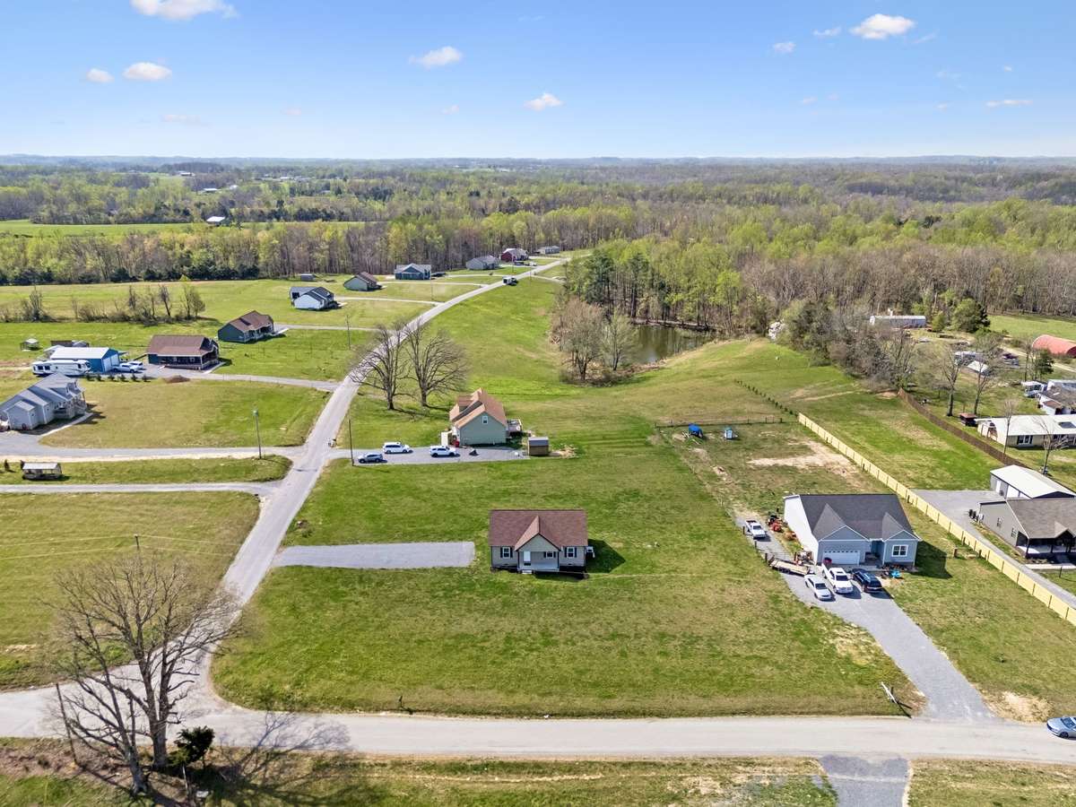 Aerial view highlighting the 1.01-acre corner lot and surrounding peaceful setting.