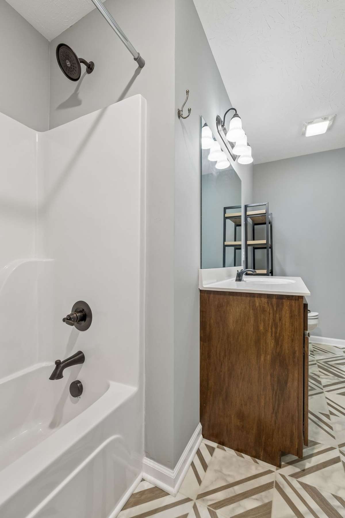 Primary bathroom with functional layout and ample storage.