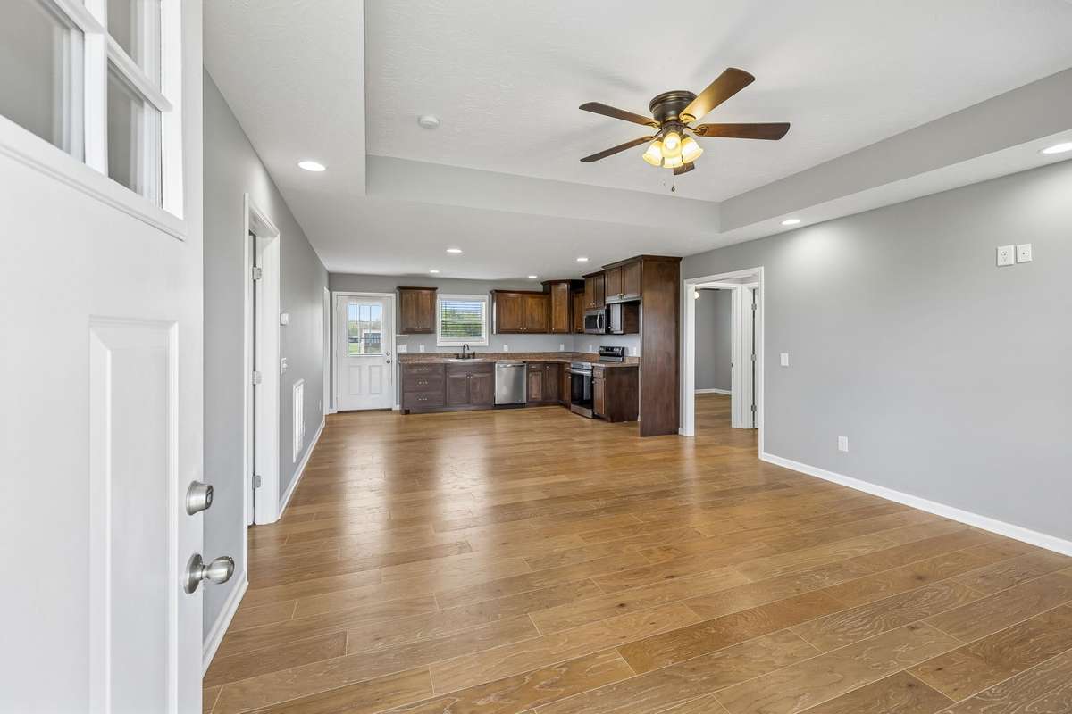 Bright and inviting living room featuring tray ceilings and an open-concept layout perfect for everyday living and entertaining.