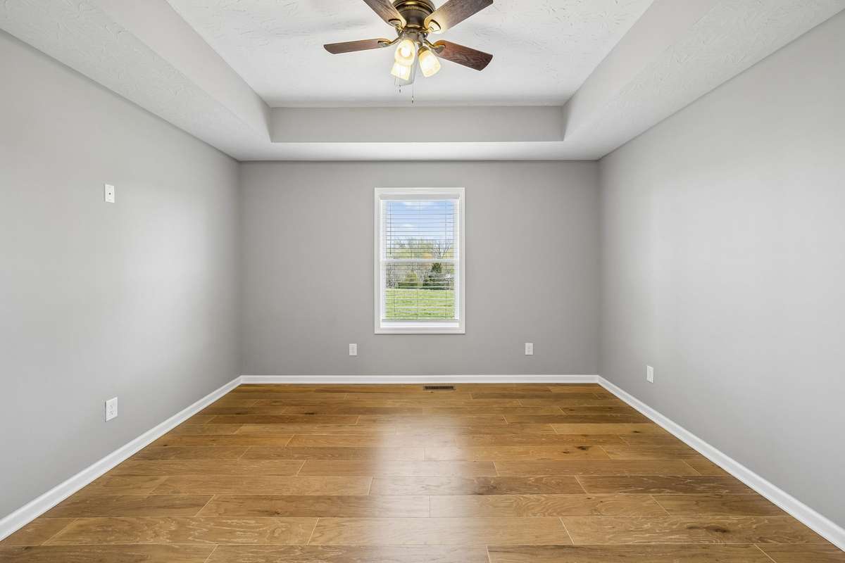 Spacious primary suite featuring tray ceilings and a comfortable, private retreat.