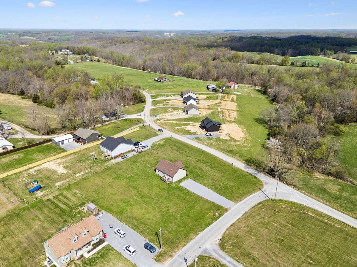Aerial view highlighting the 1.01-acre corner lot and surrounding peaceful setting.