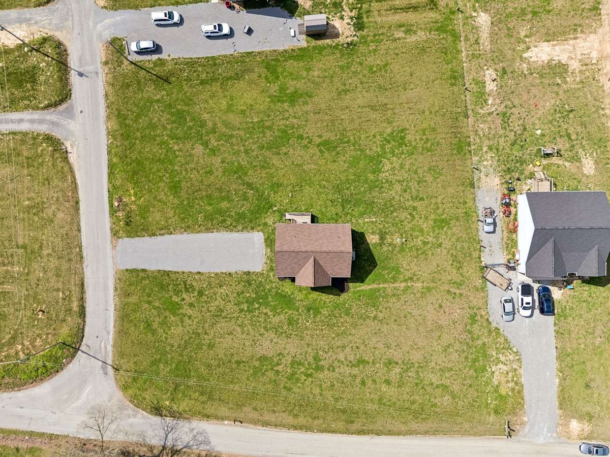 Aerial view highlighting the 1.01-acre corner lot and surrounding peaceful setting.