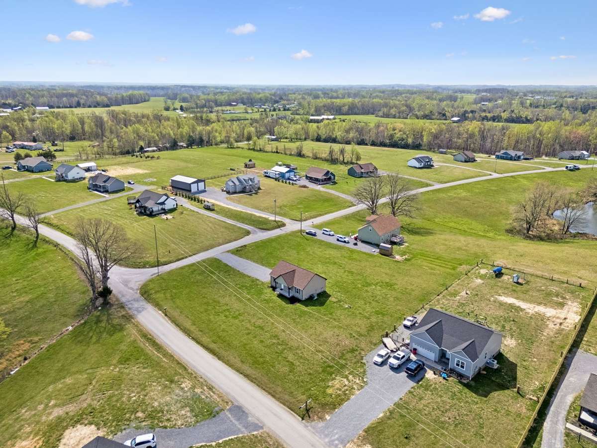 Aerial view highlighting the 1.01-acre corner lot and surrounding peaceful setting.