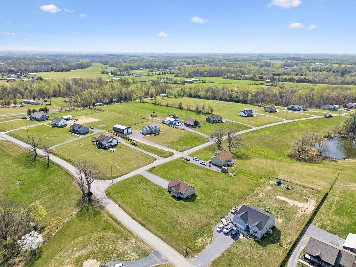 Aerial view highlighting the 1.01-acre corner lot and surrounding peaceful setting.