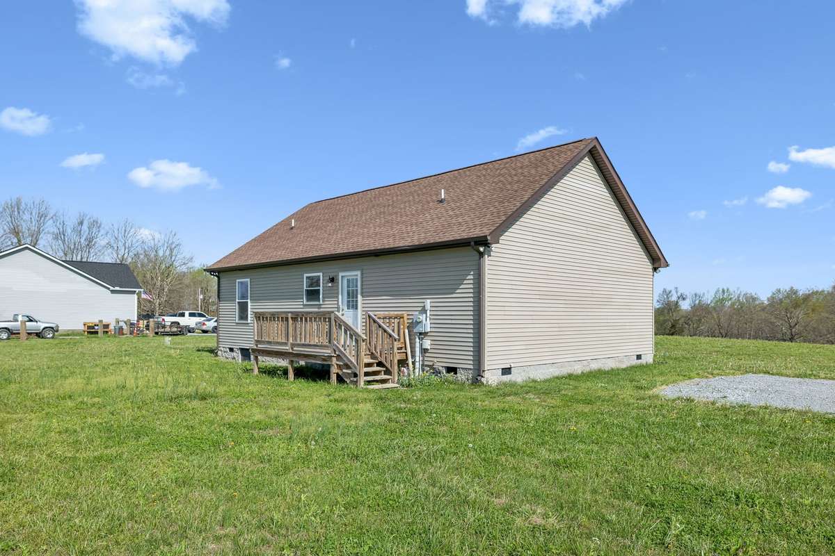 Rear view of home showcasing outdoor space and potential for entertaining or relaxing.