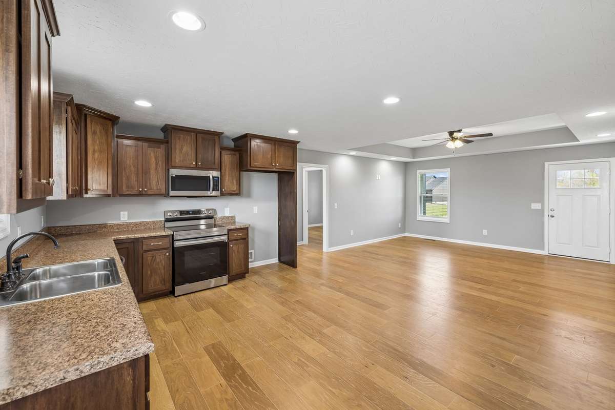 Open living area flows seamlessly into the kitchen, creating a functional and welcoming space.