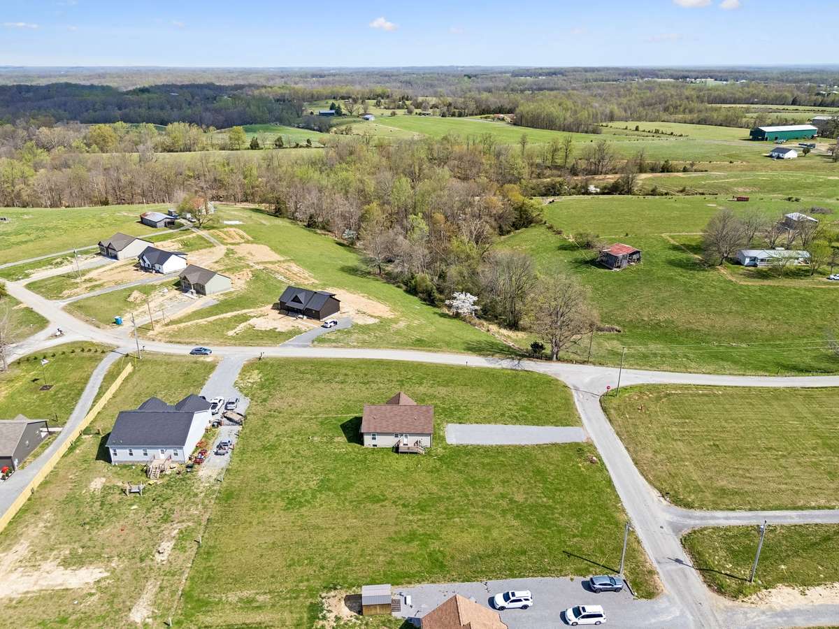 Aerial view highlighting the 1.01-acre corner lot and surrounding peaceful setting.