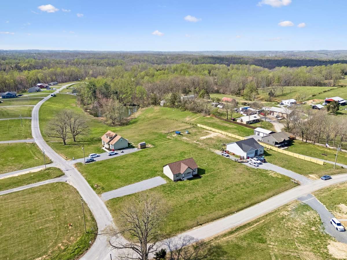 Aerial view highlighting the 1.01-acre corner lot and surrounding peaceful setting.