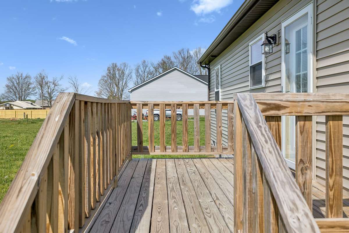 Back deck leading to kitchen door. Great for entertaining and relaxing looking out over the huge backyard.