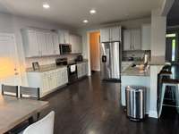 Enjoy cooking in a kitchen with stunning granite countertops, lots of cabinetry, complete with   all appliances included, making it a chef's delight!