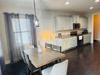 Large and spacious kitchen with a cozy eat-in-space, perfect for dining.