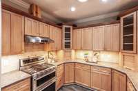 The attractive tile backsplash adds a modern touch and easy-to-clean functionality to the cooking space.