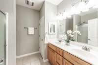 Enjoy a well-appointed en-suite bath with double vanities, plenty of counter space, and a spacious layout.