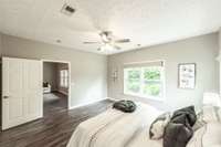 The primary suite includes a large walk-in closet and updated finishes throughout for a fresh, modern feel.